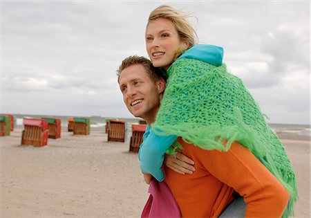 Couple on the beach under cloudy sky Stock Photo - Premium Royalty-Free, Code: 628-07072551