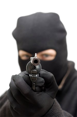 revólver - Criminal aiming a hand gun Foto de stock - Sin royalties Premium, Código: 628-07072657