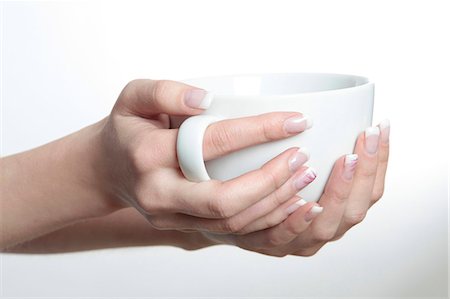 Woman's hands holding cup Photographie de stock - Premium Libres de Droits, Code: 628-07072680