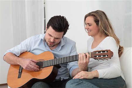 simsearch:628-07072870,k - Man playing guitar to woman on couch Stock Photo - Premium Royalty-Free, Code: 628-07072735