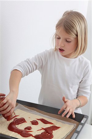 Girl preparing pizza Stock Photo - Premium Royalty-Free, Code: 628-07072744