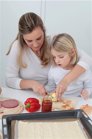 salami - Mother and daughter preparing pizza Stock Photo - Premium Royalty-Free, Code: 628-07072743
