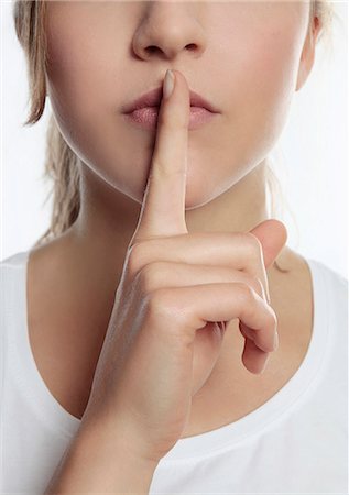 silencioso - Young woman putting finger on lips Foto de stock - Sin royalties Premium, Código: 628-07072769