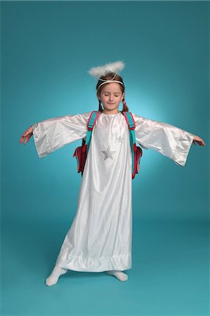 Girl dressed up as angel wearing schoolbag Stock Photo - Premium Royalty-Free, Code: 628-07072809