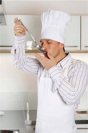 people eating at work - Cook in kitchen tasting food Stock Photo - Premium Royalty-Free, Code: 628-07072926