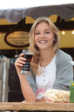 Smiling woman with soft drink on a funfair Stock Photo - Premium Royalty-Free, Code: 628-07072944