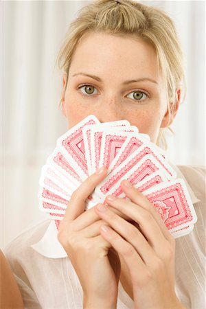 face card - Woman covering her face with cards Stock Photo - Premium Royalty-Free, Code: 628-00918921