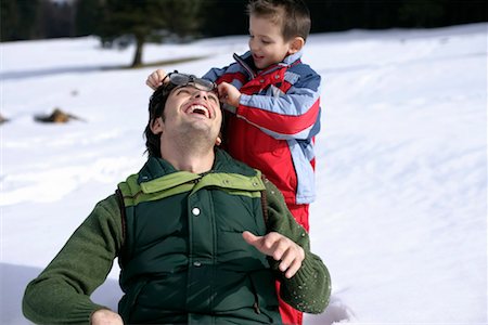 Boy taking off father's glasses Stock Photo - Premium Royalty-Free, Code: 628-00919483