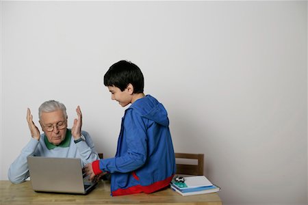 Grandfather and a boy using a laptop, fully_released Stock Photo - Premium Royalty-Free, Code: 628-00919590