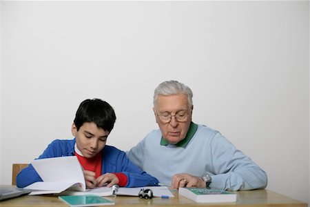 Grandfather and a boy doing homework together, fully_released Stock Photo - Premium Royalty-Free, Code: 628-00919592
