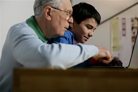 Grandfather and boy using a laptop, fully_released Stock Photo - Premium Royalty-Free, Code: 628-00919617