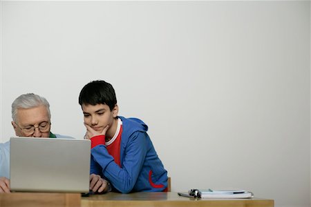 Grandfather and boy using a laptop, fully_released Stock Photo - Premium Royalty-Free, Code: 628-00919636