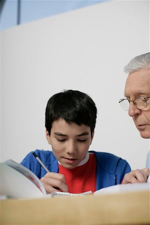 Grandfather and boy doing homework together, fully_released Stock Photo - Premium Royalty-Free, Code: 628-00919638