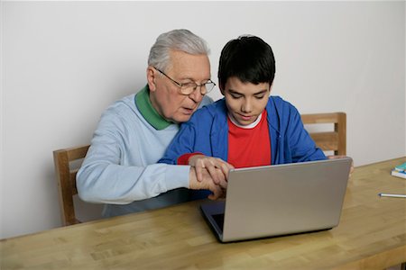 Grandfather and boy using a laptop, fully_released Stock Photo - Premium Royalty-Free, Code: 628-00919632