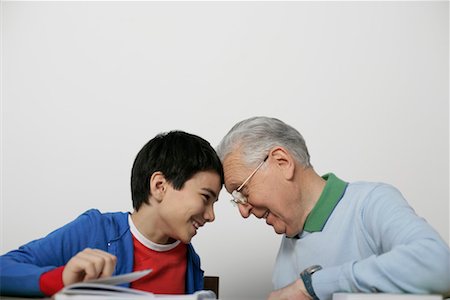 simsearch:628-00919621,k - Grandfather and boy sitting head to head laughing, fully_released Stock Photo - Premium Royalty-Free, Code: 628-00919652