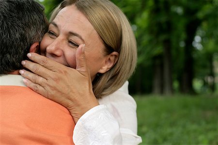 Mature couple embracing each other, woman whispering something in man's ear Stock Photo - Premium Royalty-Free, Code: 628-00919789