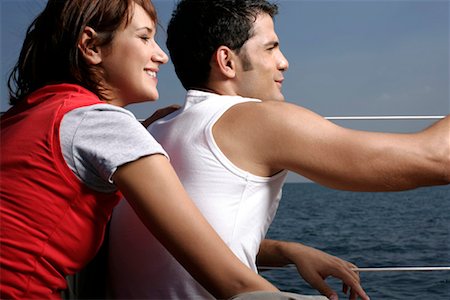 friends sailing - Couple sitting at sailboat border Stock Photo - Premium Royalty-Free, Code: 628-00919888