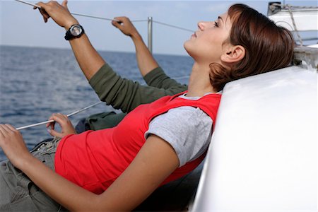 friends sailing - Couple lying at sailboat border Stock Photo - Premium Royalty-Free, Code: 628-00919905