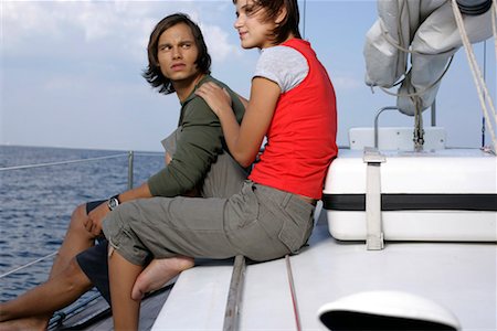 friends sailing - Couple sitting on a sailboat Stock Photo - Premium Royalty-Free, Code: 628-00919918
