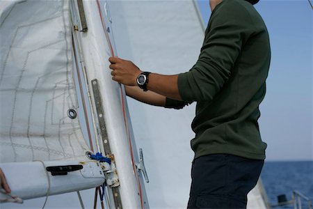 Man hoisting a sail Foto de stock - Sin royalties Premium, Código: 628-00919921