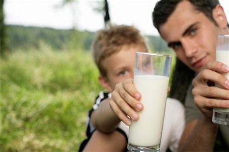 simsearch:628-00919973,k - Father and son holding glasses of milk at camera Stock Photo - Premium Royalty-Free, Code: 628-00920007