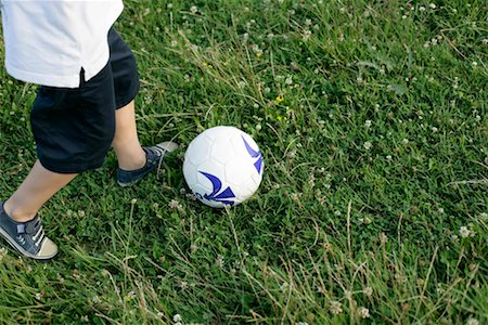 feet in the meadow - Boy playing soccer Stock Photo - Premium Royalty-Free, Code: 628-00920044