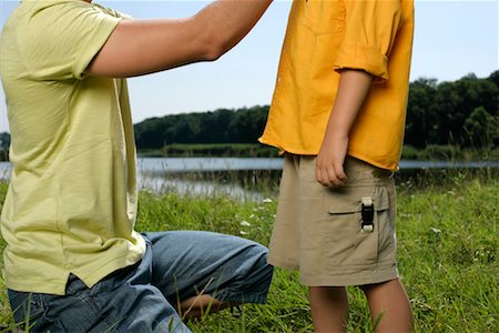 simsearch:628-00919973,k - Father kneeling in front of his son in grass Stock Photo - Premium Royalty-Free, Code: 628-00920048