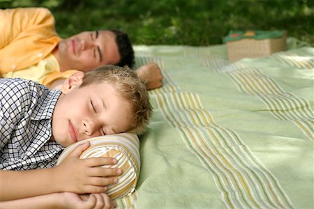 Father and son sleeping on a blanket Stock Photo - Premium Royalty-Free, Code: 628-00920050