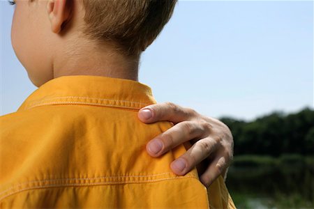 Father's hand on son's shoulder Stock Photo - Premium Royalty-Free, Code: 628-00920063