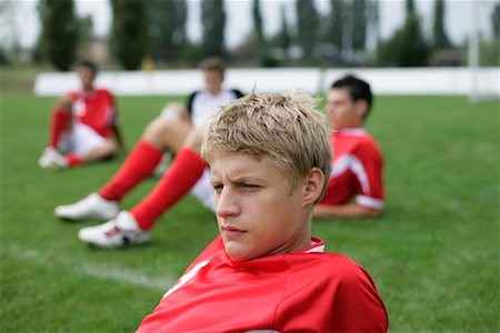 exhausted football player - Soccer players sitting on grass Stock Photo - Premium Royalty-Free, Code: 628-00920116