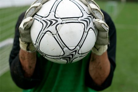soccer goalie hands - Goalkeeper holding football in his hands Stock Photo - Premium Royalty-Free, Code: 628-00920121