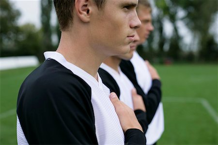 Soccer players with right hands on their hearts Stock Photo - Premium Royalty-Free, Code: 628-00920156