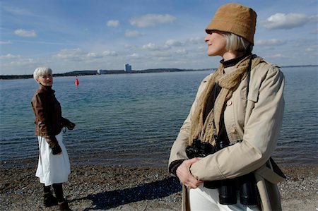 Two mature women looking each other at Baltic Sea beach Stock Photo - Premium Royalty-Free, Code: 628-00920275