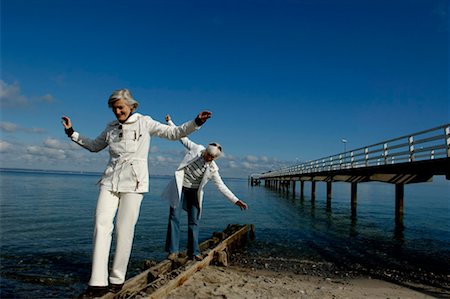 Two mature women balancing over a beam at Baltic Sea beach Stock Photo - Premium Royalty-Free, Code: 628-00920286