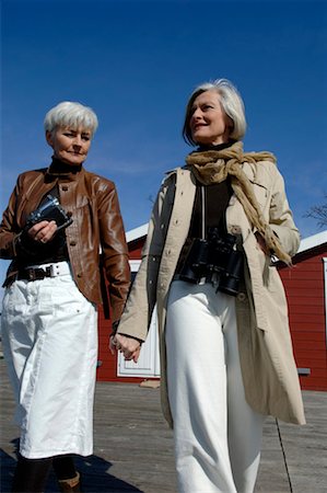 Two mature women holding hands and walking Stock Photo - Premium Royalty-Free, Code: 628-00920293