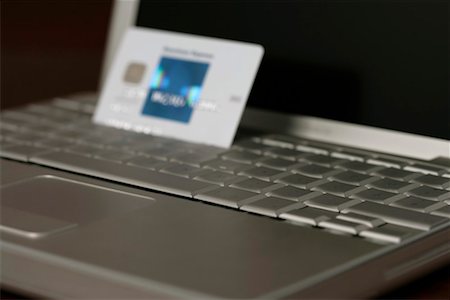 simsearch:628-03201079,k - Credit card sticking between the keys of a laptop (part of), close up Stock Photo - Premium Royalty-Free, Code: 628-00920432