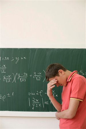 simsearch:628-00920637,k - Helpless teenage boy in front of a blackboard with an arithmetic problem Stock Photo - Premium Royalty-Free, Code: 628-00920664