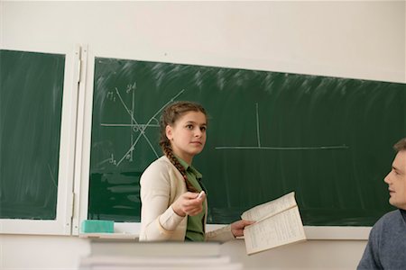 simsearch:628-00920637,k - Teenage girl explaining a problem at blackboard, teacher is watching her Stock Photo - Premium Royalty-Free, Code: 628-00920675