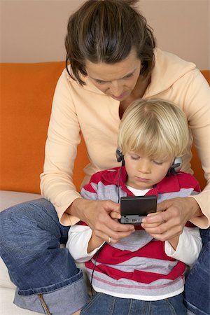 simsearch:628-01279508,k - Mother and son (4-5 Years) playing hand held computer game Stock Photo - Premium Royalty-Free, Code: 628-01278205