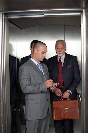 simsearch:628-01639078,k - Three businessmen in a lift Foto de stock - Sin royalties Premium, Código: 628-01278396