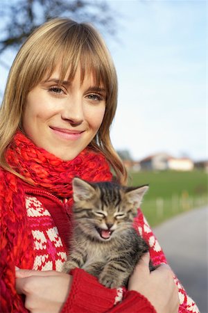 Young woman with a kitten on her arm, close-up Stock Photo - Premium Royalty-Free, Code: 628-01278464