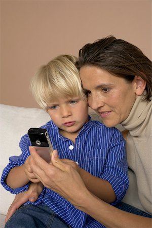 simsearch:628-01279508,k - Mother and son (4-5 Years) looking at a mobile phone Stock Photo - Premium Royalty-Free, Code: 628-01278561