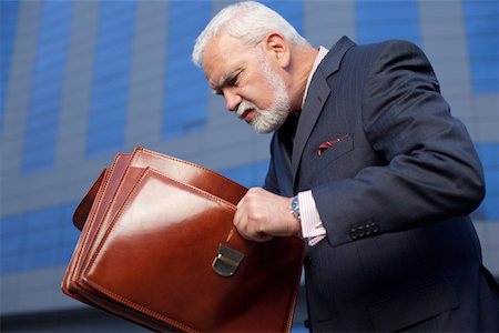 simsearch:628-01278542,k - Mature businessman looking into a briefcase Stock Photo - Premium Royalty-Free, Code: 628-01278629