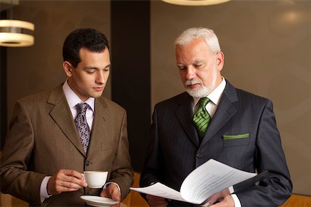 simsearch:628-01278542,k - Two businessmen reading documents Stock Photo - Premium Royalty-Free, Code: 628-01278633