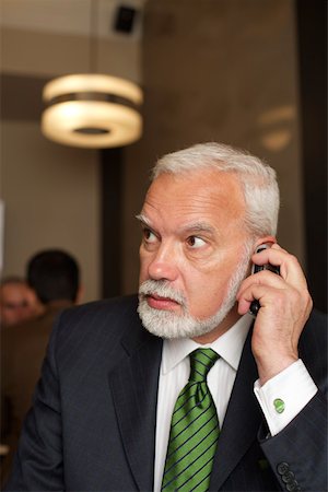 simsearch:628-01278542,k - Mature businessman phoning with a mobile phone in a cafe Stock Photo - Premium Royalty-Free, Code: 628-01278650