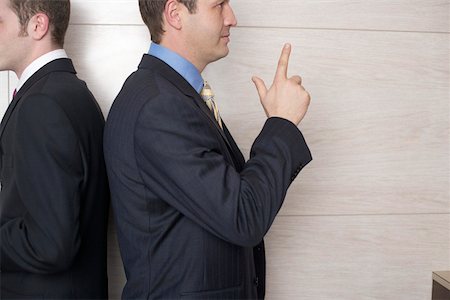 symbol finger - Two businessmen standing back to back Stock Photo - Premium Royalty-Free, Code: 628-01278777