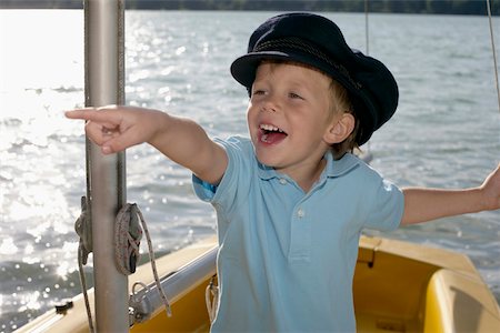 simsearch:628-03201079,k - Little boy in a plastic boat is pointing at something, close-up Stock Photo - Premium Royalty-Free, Code: 628-01278911