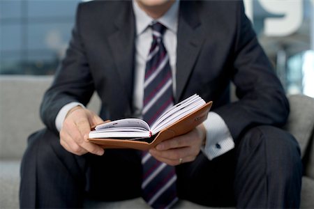 diary page - Businessman looking in his diary Stock Photo - Premium Royalty-Free, Code: 628-01278945