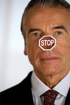 simsearch:693-03304499,k - Senior businessman with a STOP label on his nose Stock Photo - Premium Royalty-Free, Code: 628-01279193