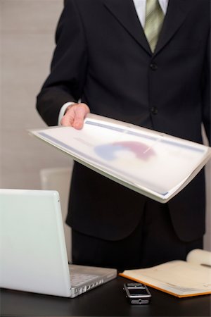 Businessman handing over documents in his office Stock Photo - Premium Royalty-Free, Code: 628-01279345